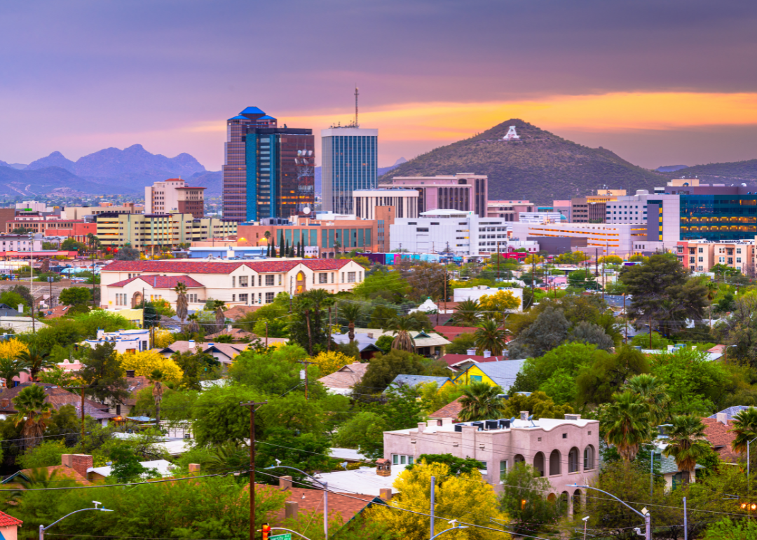 An aerial view of Tucson with mountains in the background.