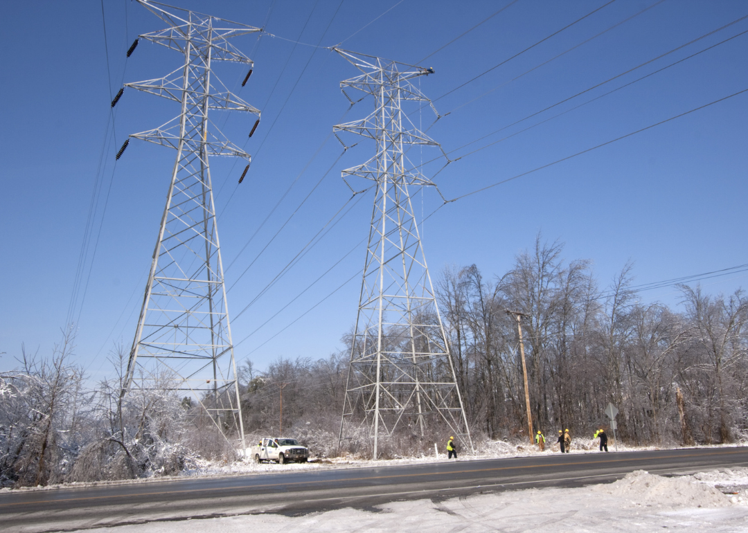 Technicians working on restoring service at a high tension power line feeding southern Louisville.
