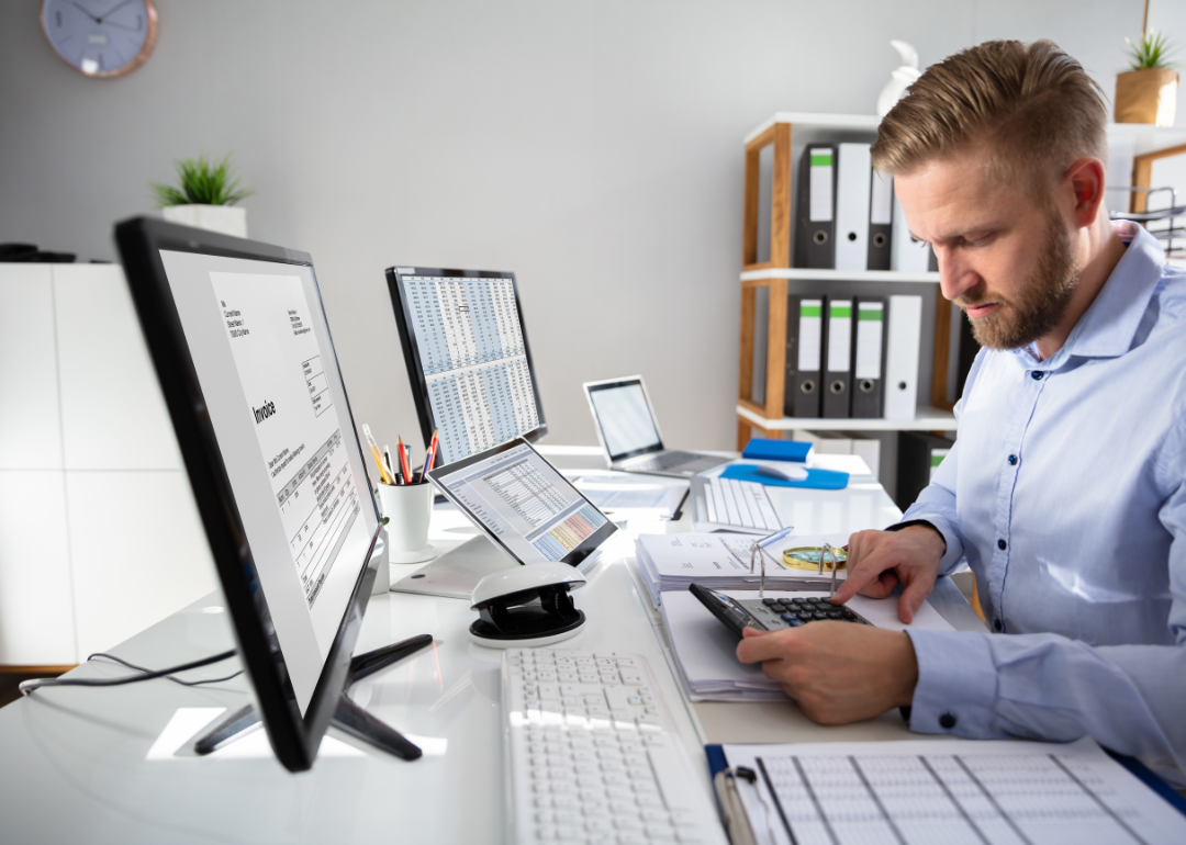 A businessperson doing calculations for an invoice.