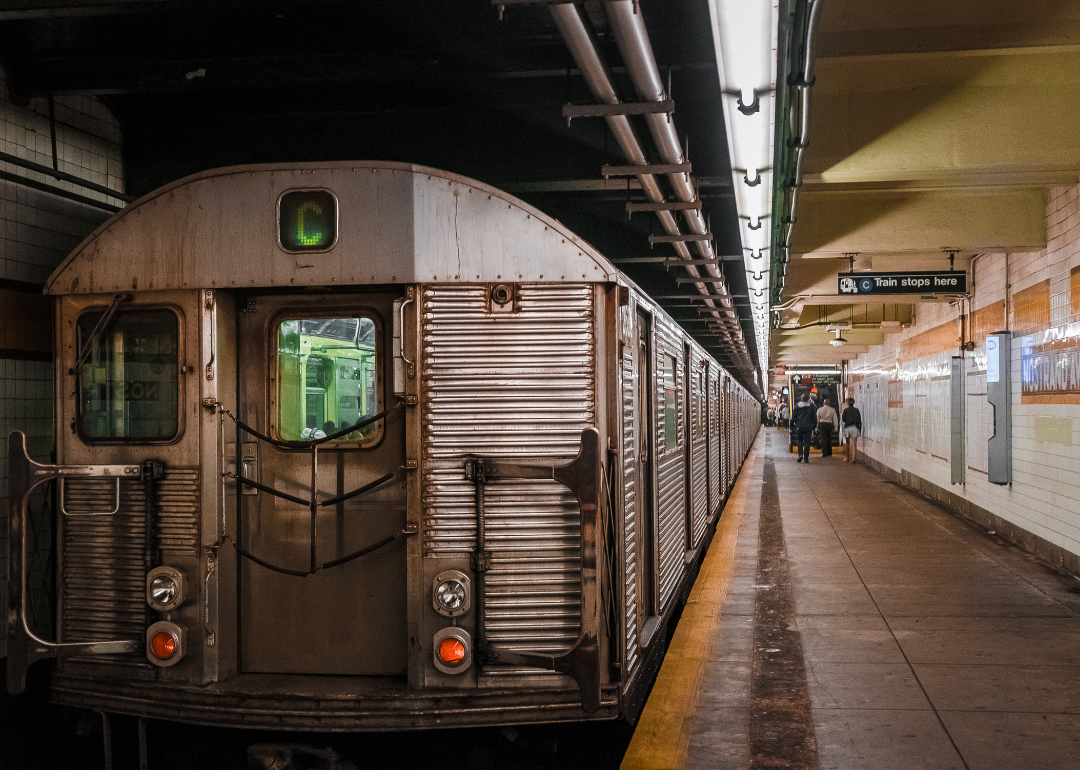 A gray train stopped in a subway station.
