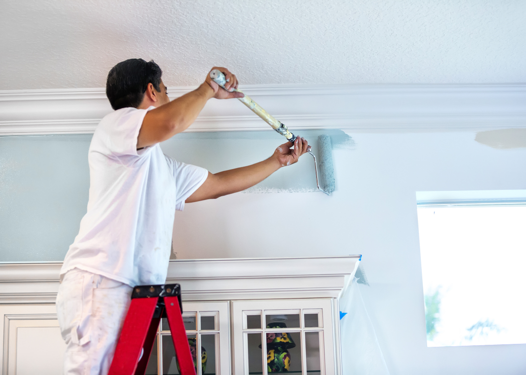 A house painter painting a residential home