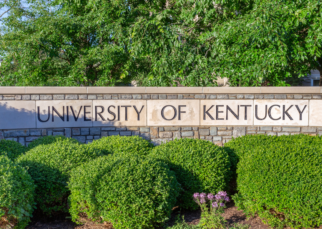 The entrance sign and foliage background leading to the campus of the University of Kentucky.