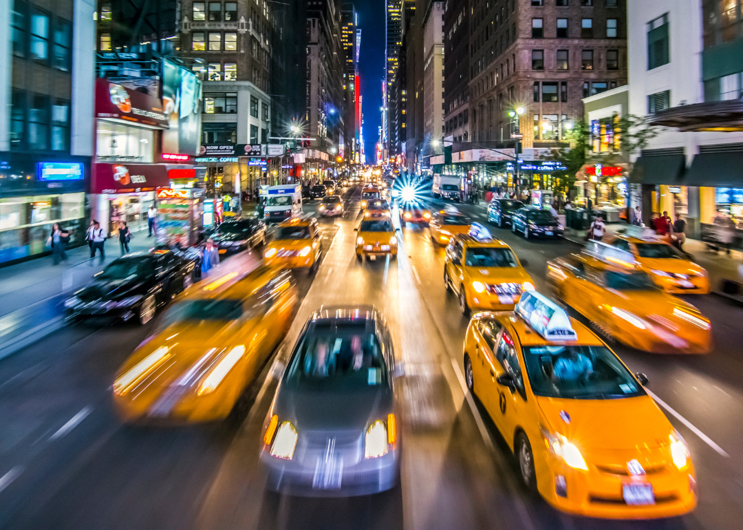 A street-level view of New York City at night.