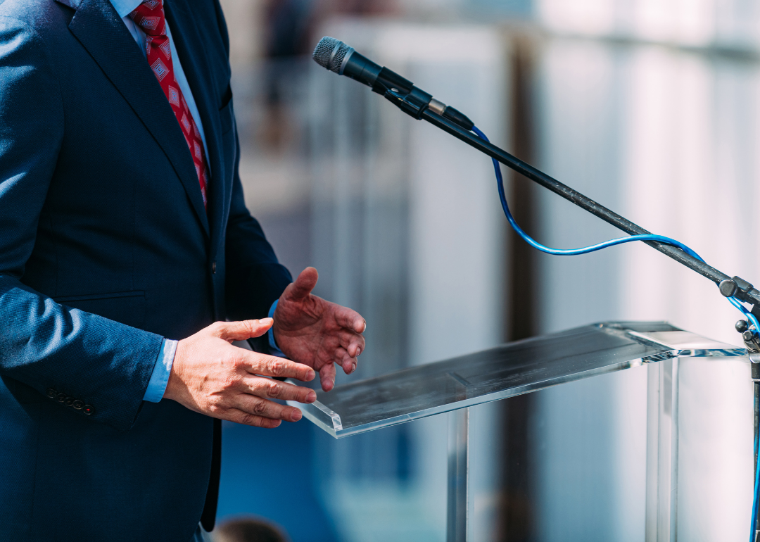 A politician speaking at a podium during their election campaign.