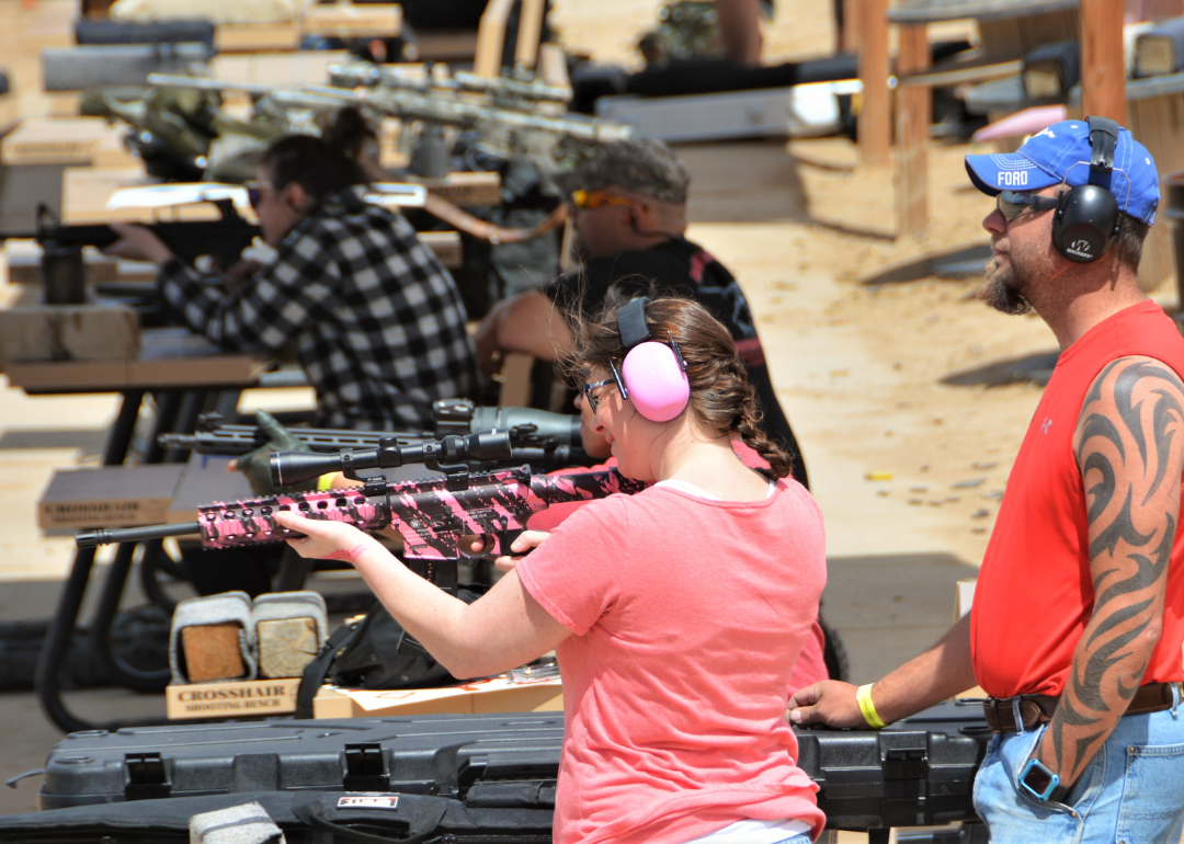 A person shooting a pink AR-15 at Dragon Mans shooting range in Colorado Springs.