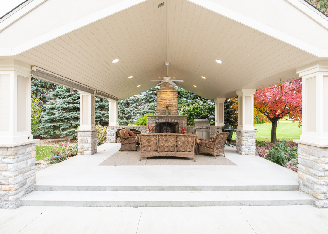 A luxury covered patio with a fireplace in Clio, Michigan.