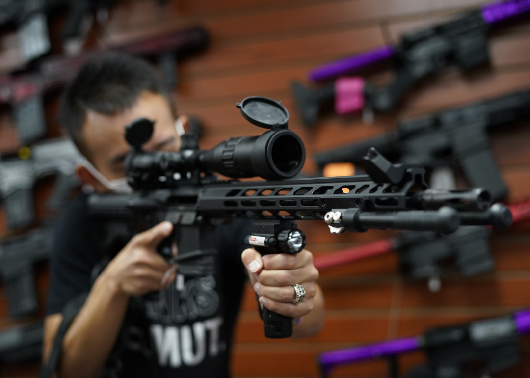 A person showing off a long gun at Jimmy's Sport Shop in Mineola.