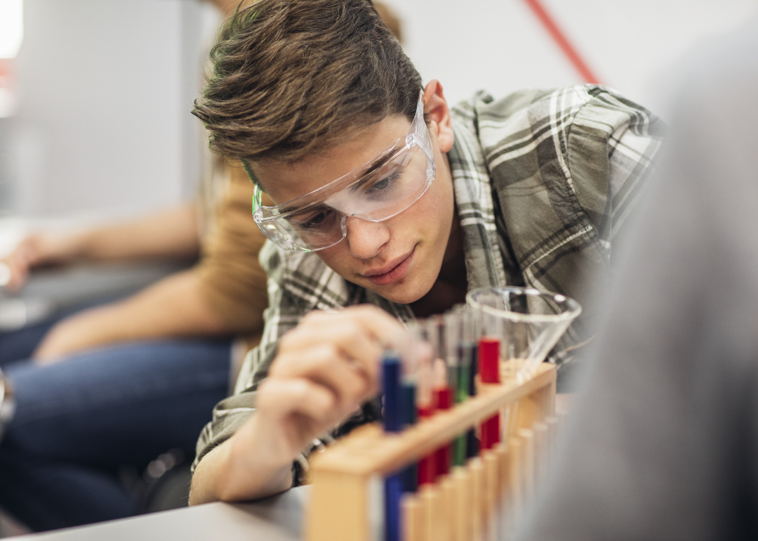 A high school student doing a chemical experiment.