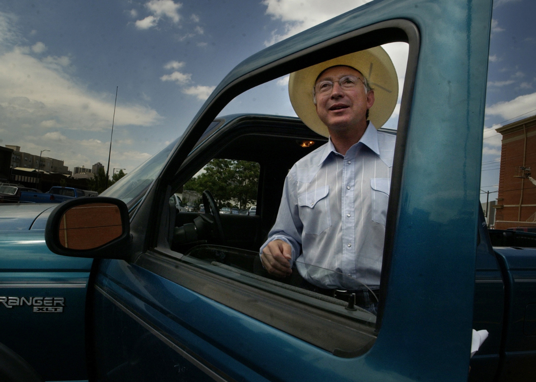 A man standing inside the door of his green Ford Ranger pickup in 2004.