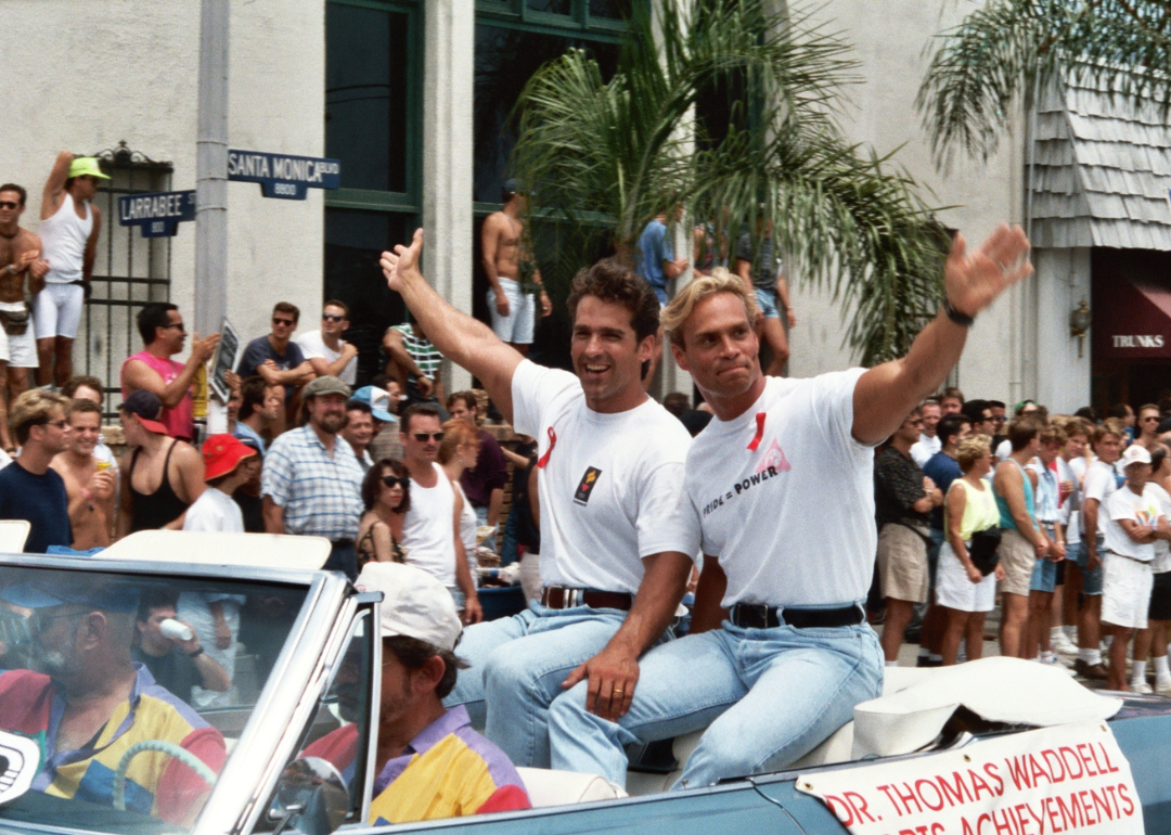 Bob Paris and Rod Jackson in a car during a parade.