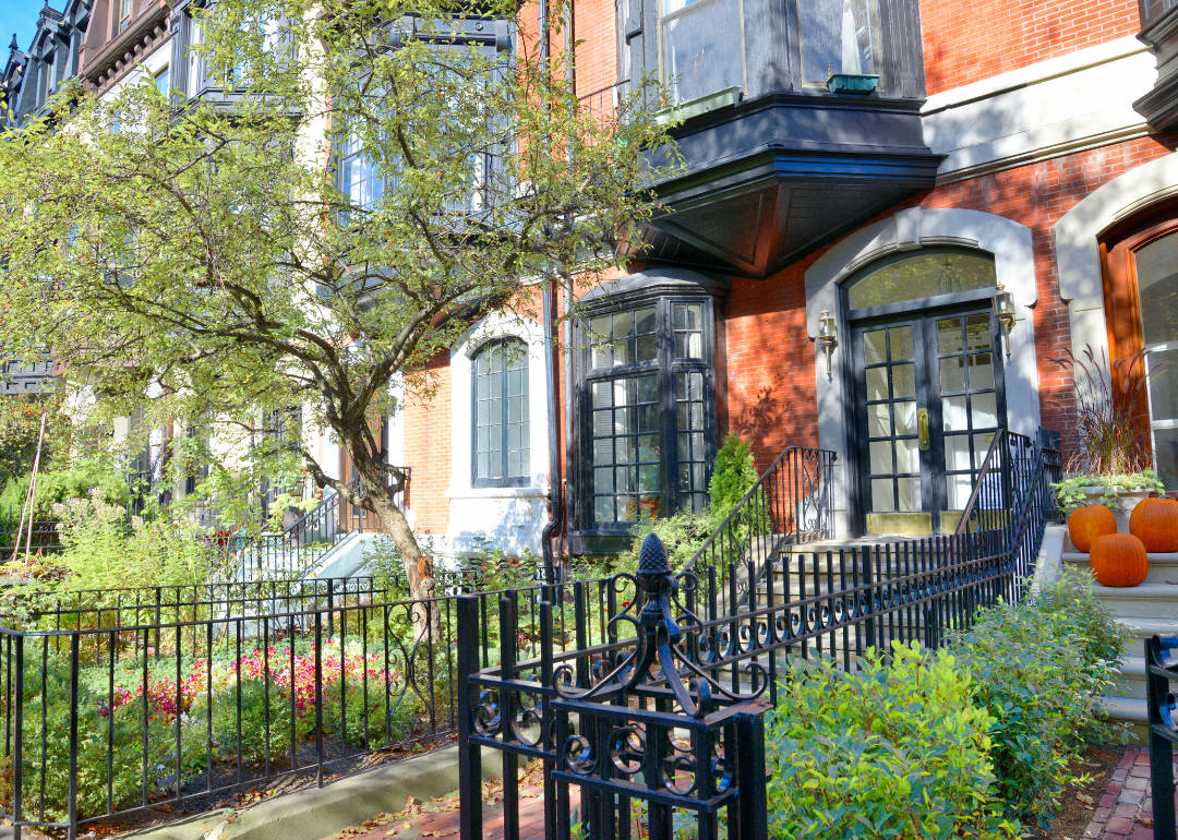 Boston townhomes with pumpkins outside them for Halloween.