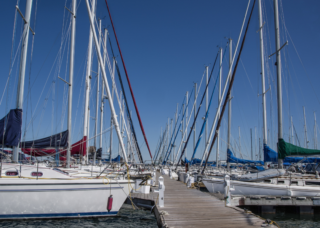 Rows of sailing sloops facing one another across a wooden pier on Lake Superior in northern Wisconsin.