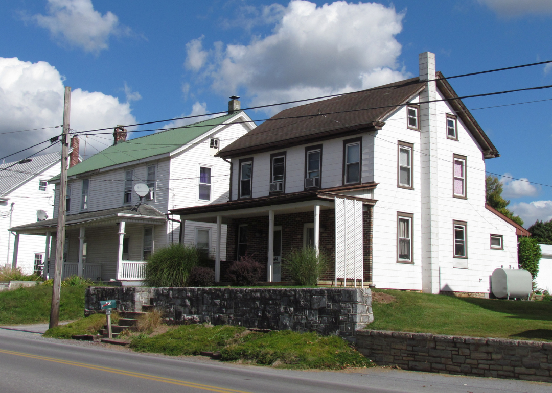 Two white houses on a street