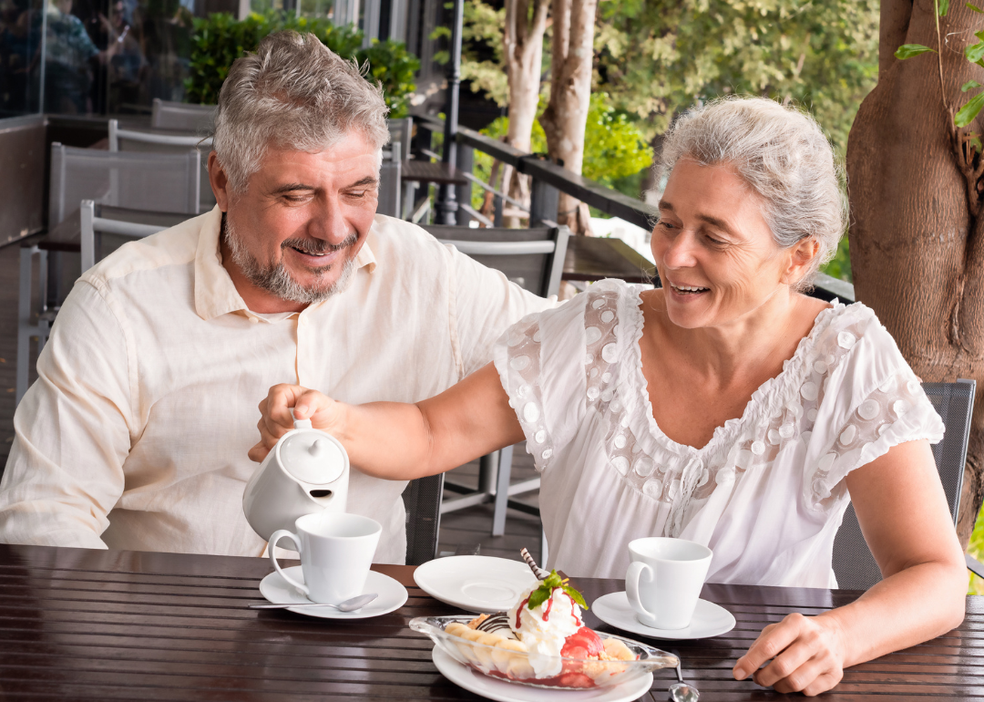 A retired couple having coffee.