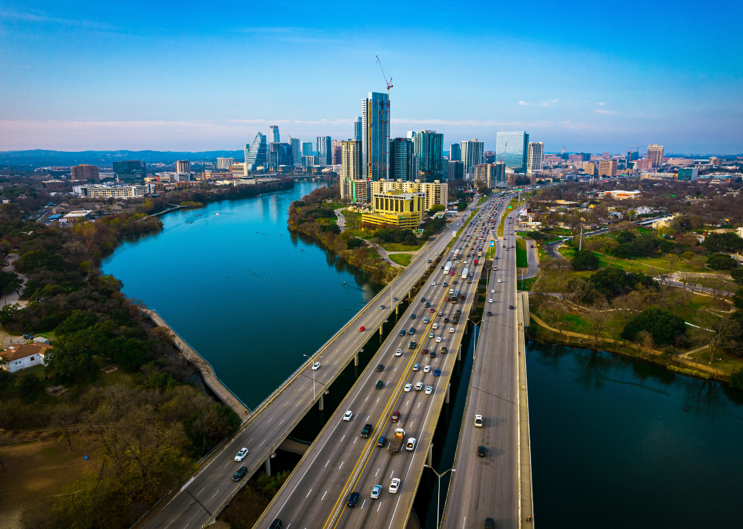 An aerial drone view of the Colorado River and Interstate 35 leading into Austin, Texas.