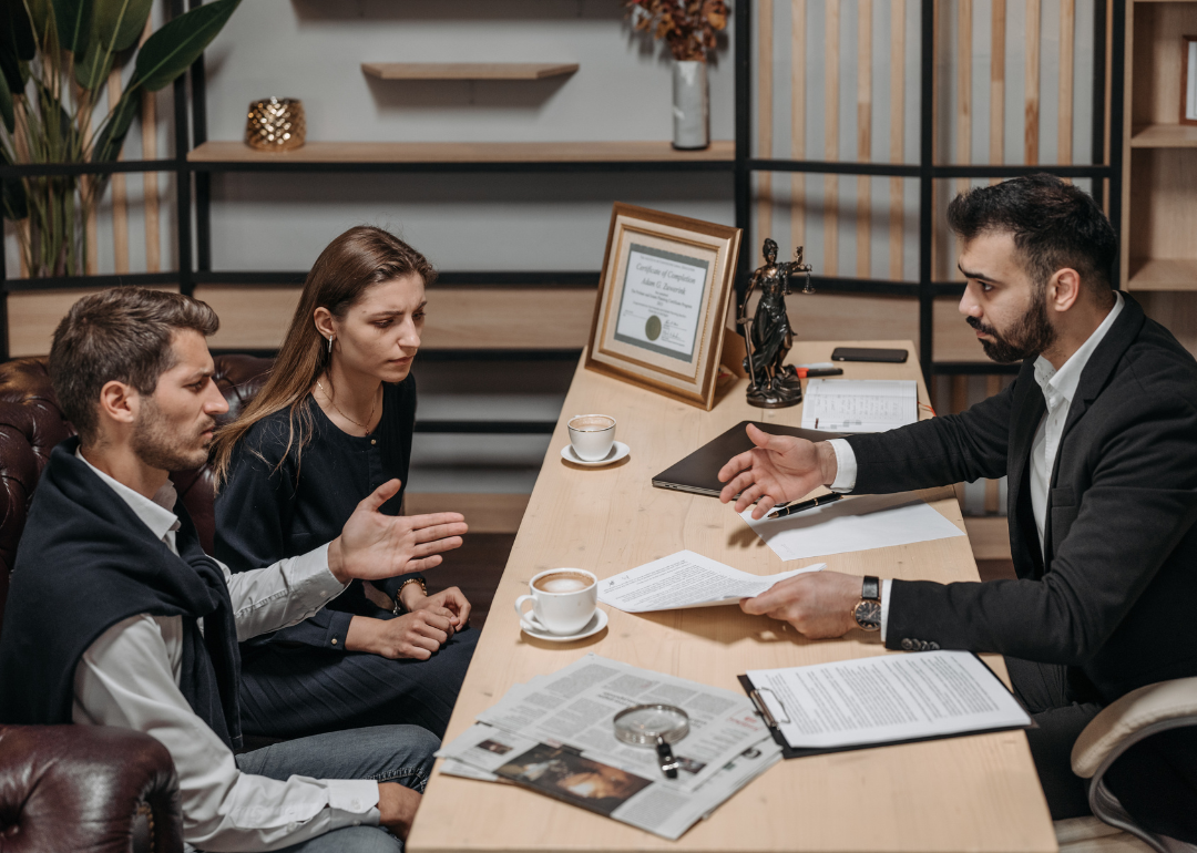 A lawyer talking to clients in their office.