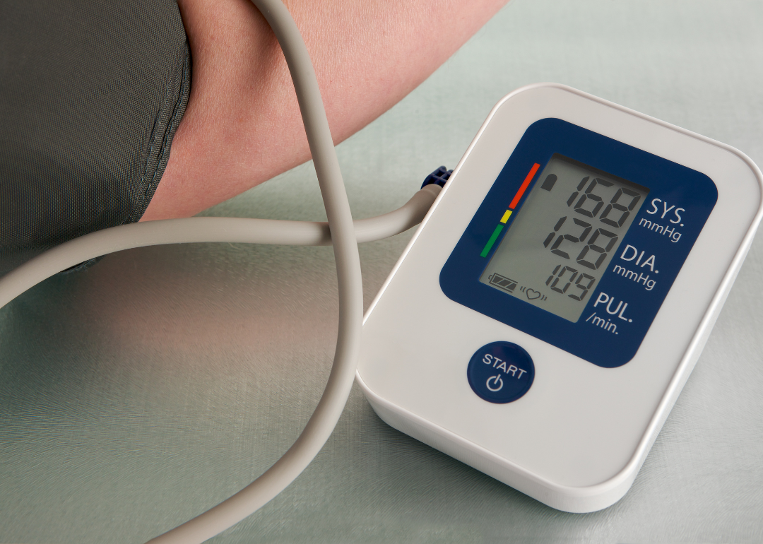 A person getting a high blood pressure reading from a digital monitor.