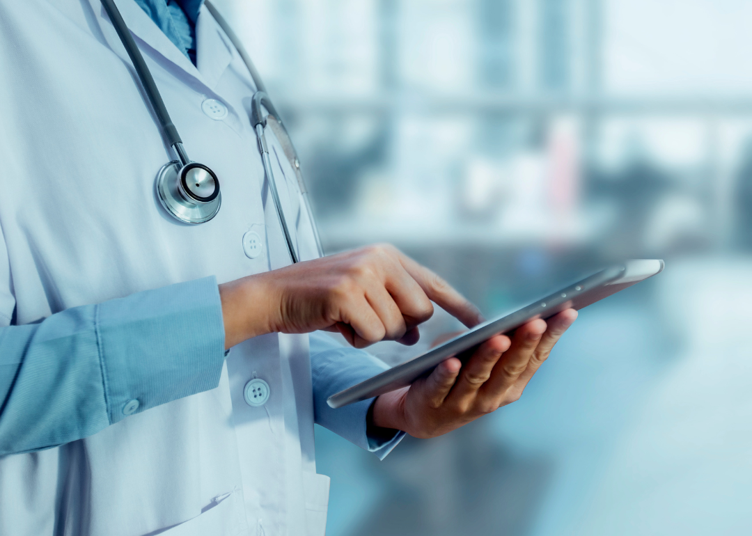 A doctor entering data into a tablet.