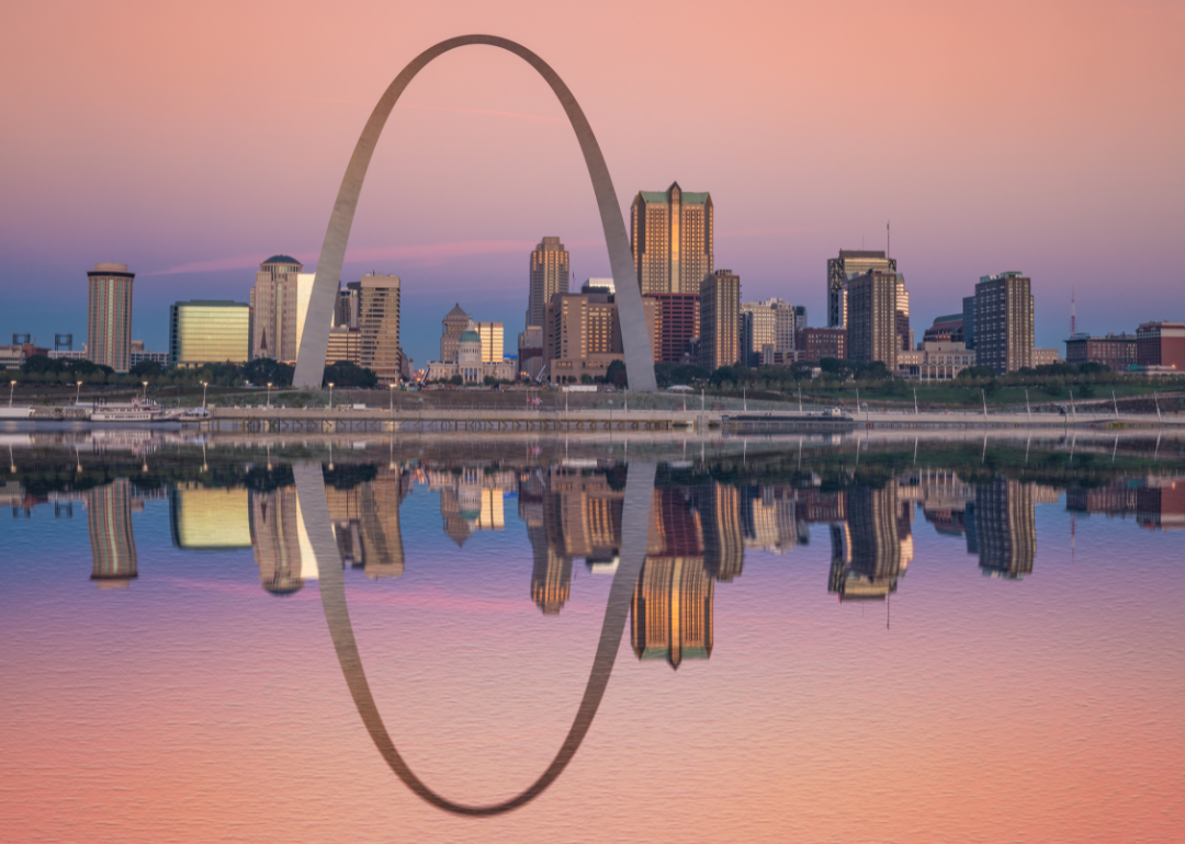 St. Louis and its iconic arch being reflected in water at sunrise.