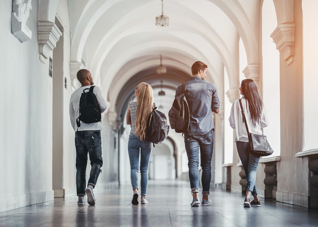 Students walking down a university hallway.