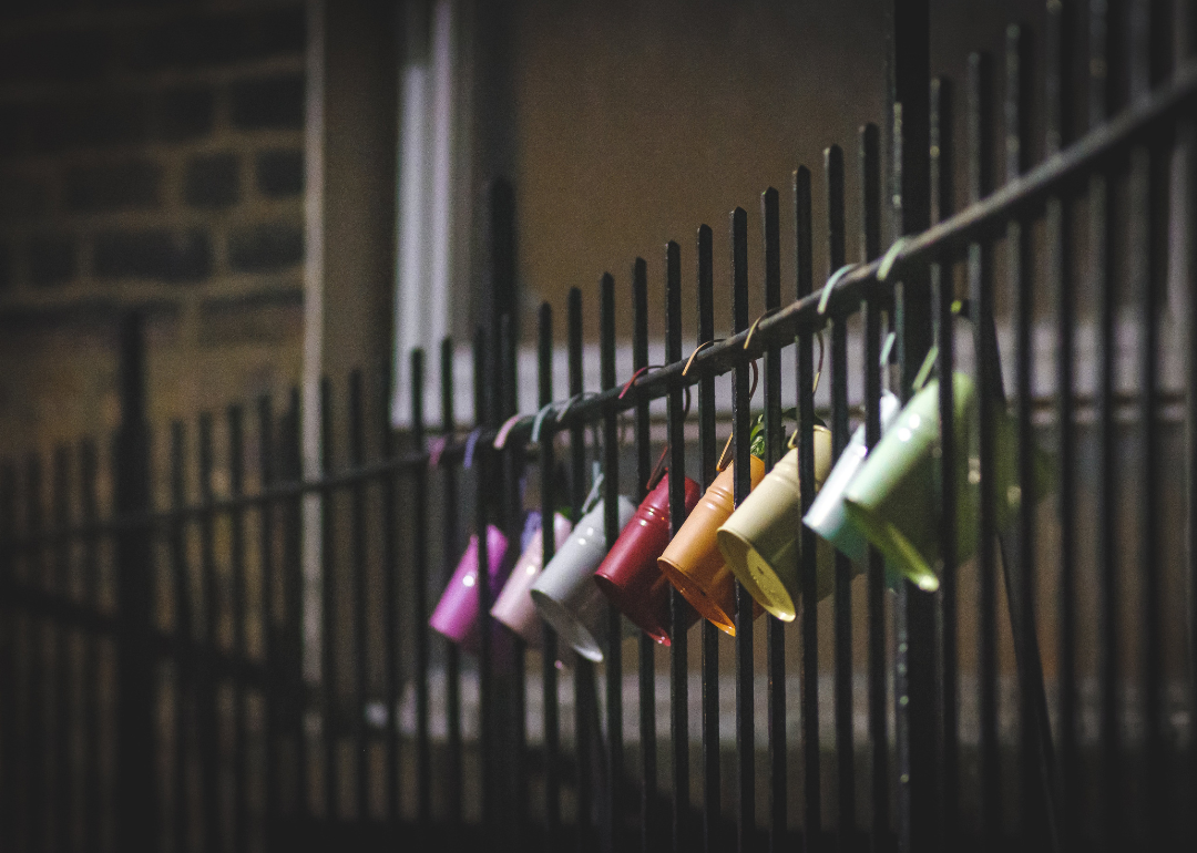 Metal buckets hanging from a fence