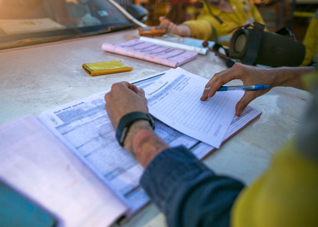 A compliance officer taking notes about a coal mine