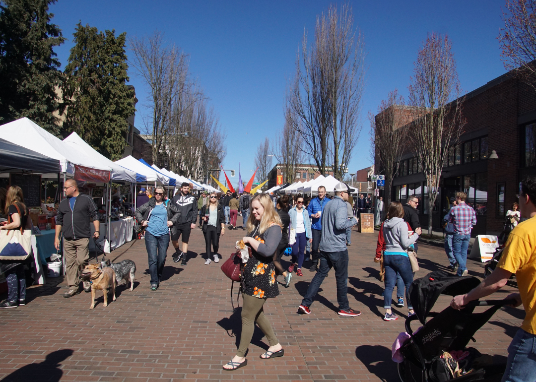 People exploring the Ballard Farmer's Market in Seattle.