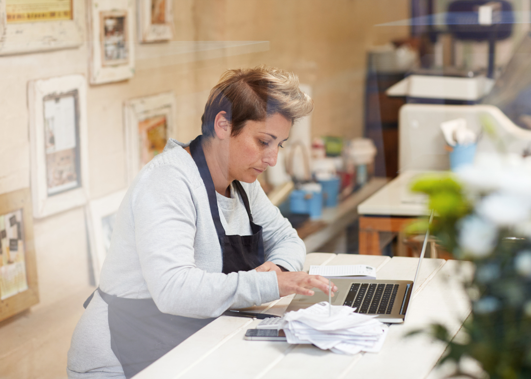 A deli worker calculating their taxes.