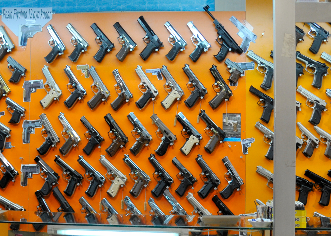 Handguns on a display wall in a gun store.