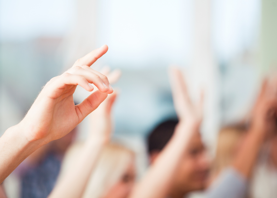 Students raising their hands for class participation.