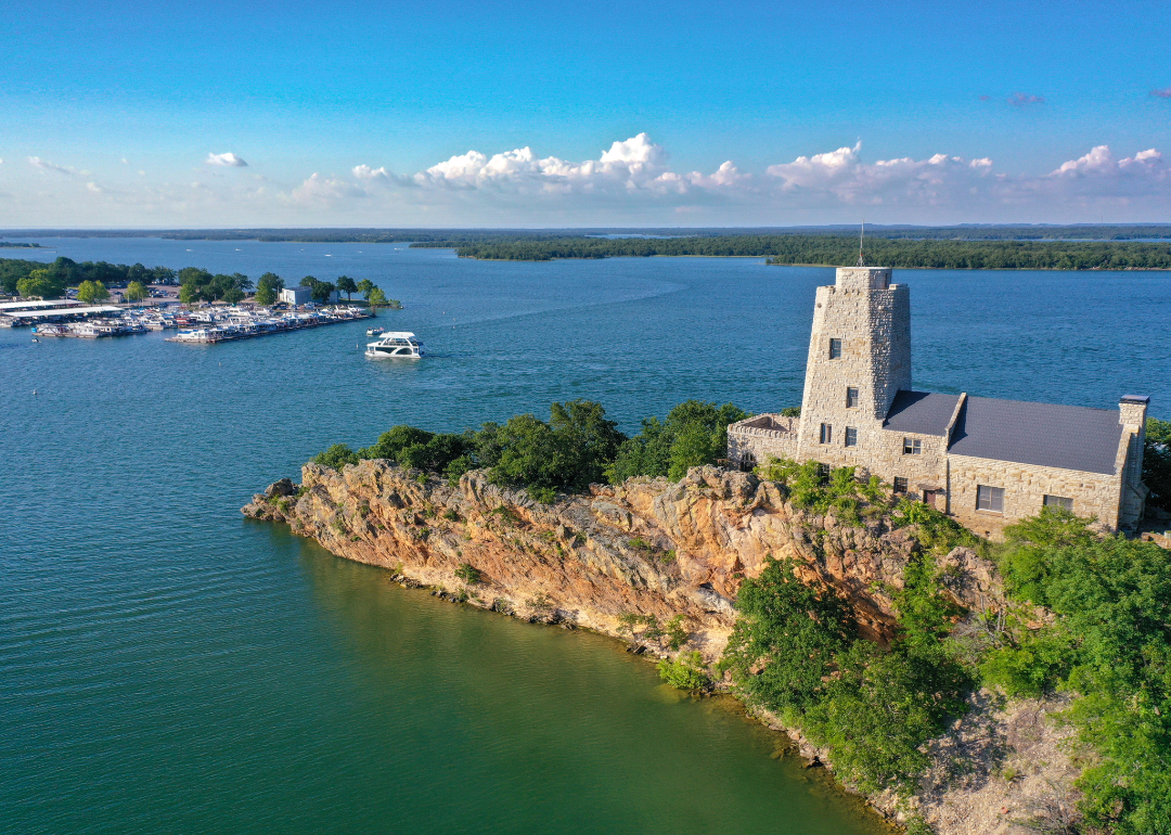 An aerial view of Tucker Tower on Lake Murray in Ardmore with a houseboat in the distance on a summer day.