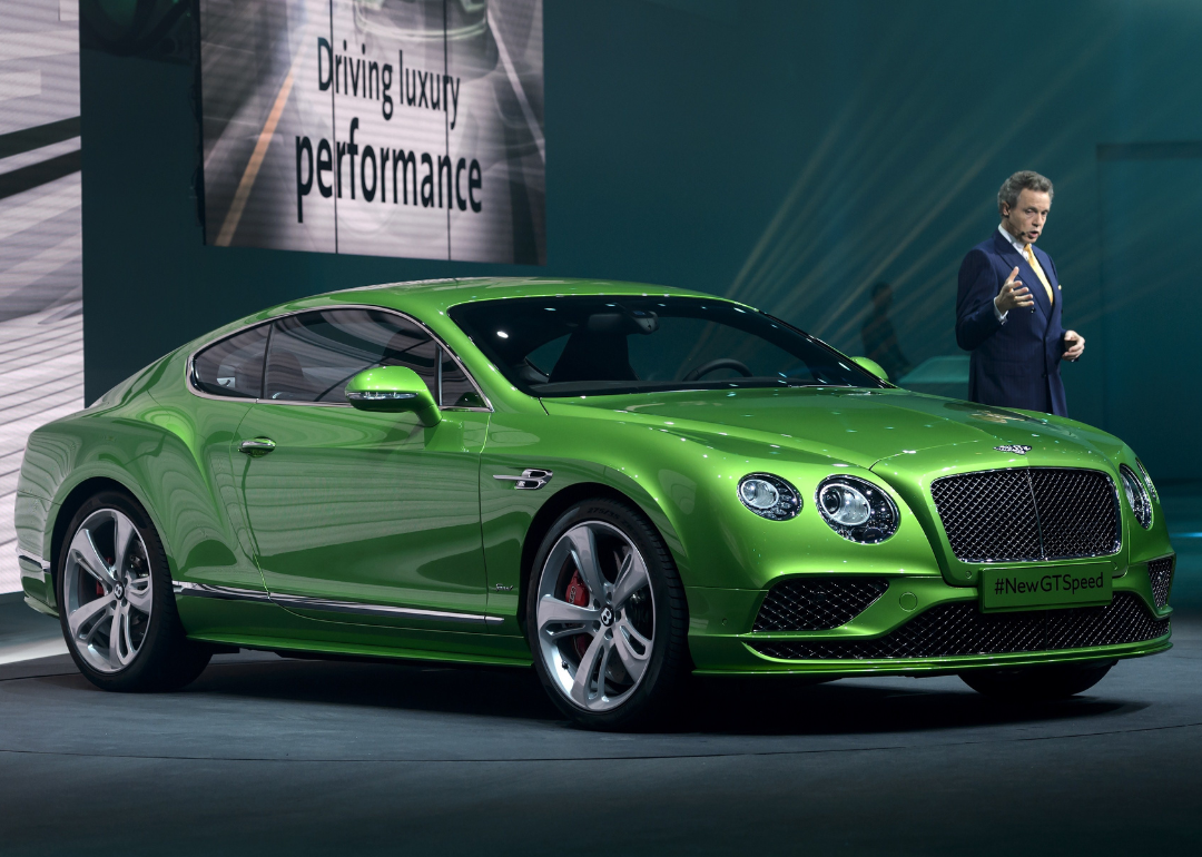 Chairman and Chief Executive of Bentley Motors Wolfgang Duerheimer presenting the Bentley Continental GT Speed model car during a preview of German carmaker Volkwagen Group on March 2, 2015.