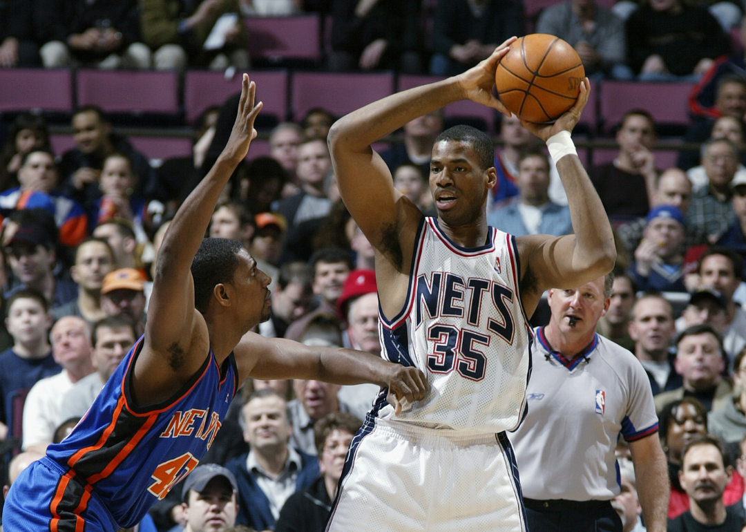 Jason Collins #35 of the New Jersey Nets looks to pass against Kurt Thomas #40 of the New York Knicks during an NBA game at Continental Airlines Arena on March 26, 2003.