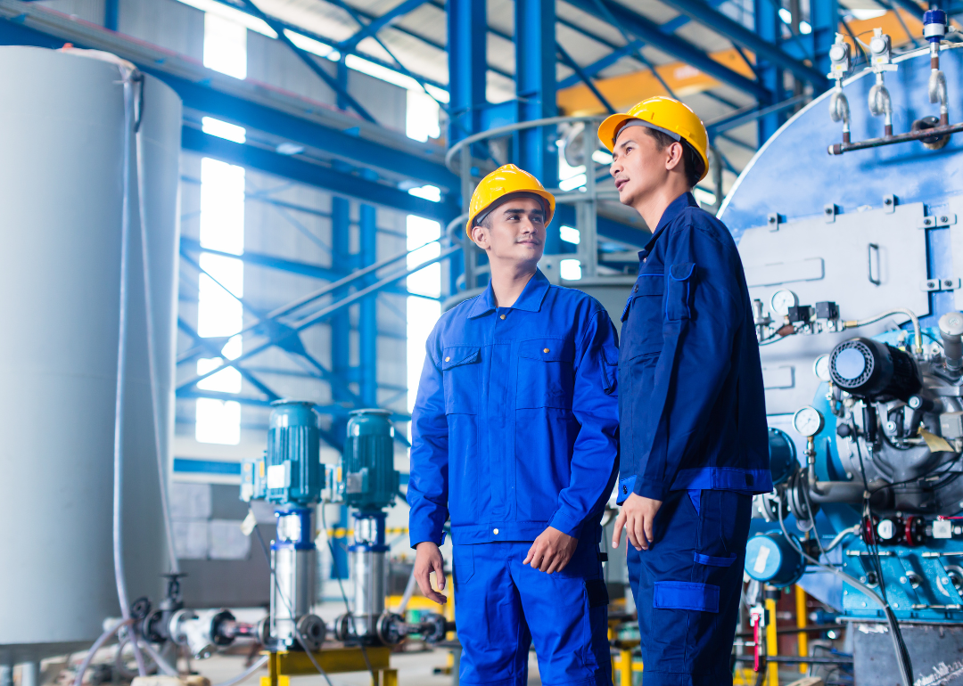 Two workers at a manufacturing plant.