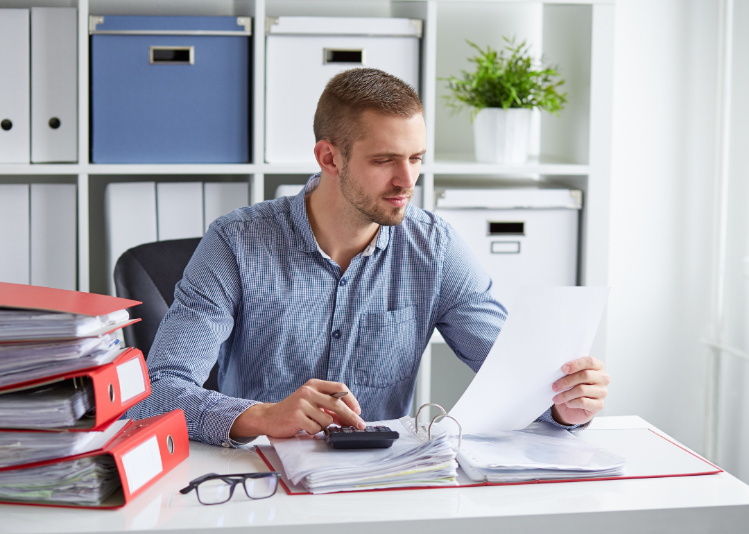 A payroll administrator making calculations.