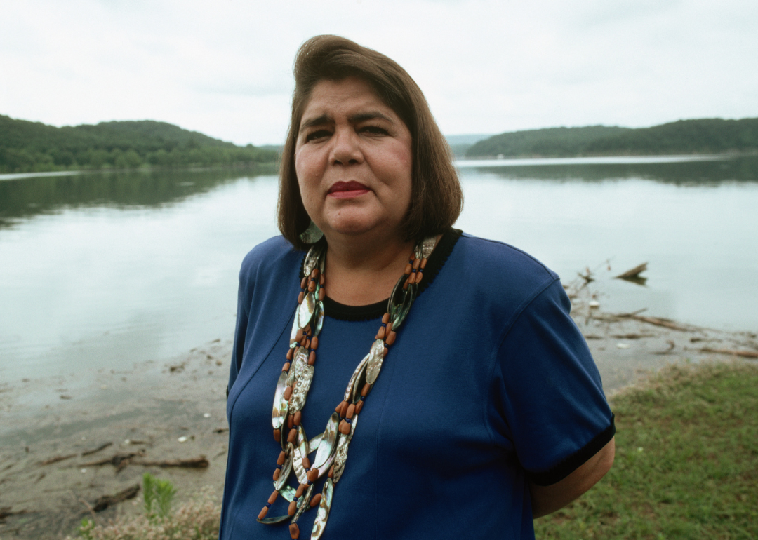 Wilma Mankiller, principal chief of the Cherokee Nation, posing beside a lake. 