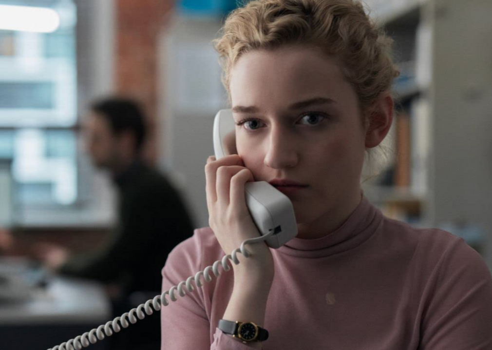 A closeup of Julia Garner speaking on the phone in the film, The Assistant.