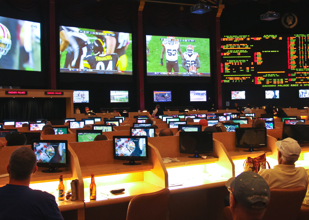 Gamblers watch football games at a sports book.