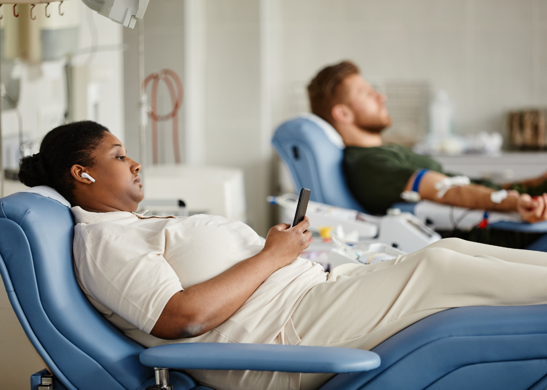 Two people giving blood.