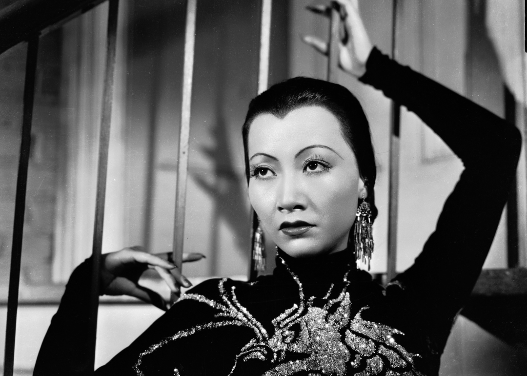 Chinese American film star Anna May Wong wearing a dress with a dragon motif in a publicity shot for 'Limehouse Blues', directed by Alexander Hall. 