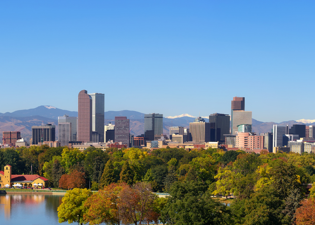 The skyline of downtown Denver with the Rocky Mountains in the background.
