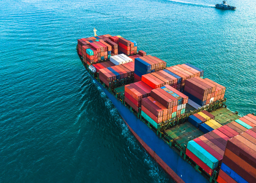 An aerial view of a cargo ship filled with shipping containers.