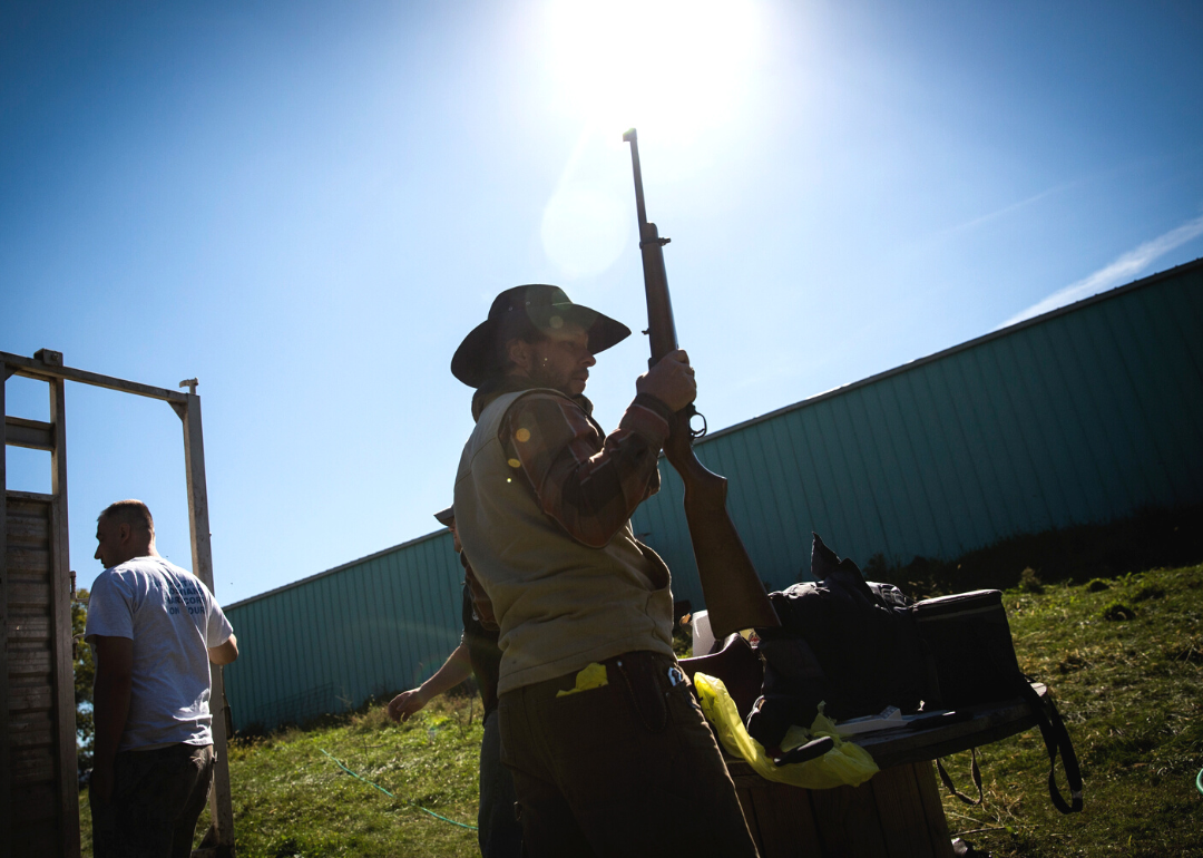 Cattle farmer in Raymond putting his rifle away.