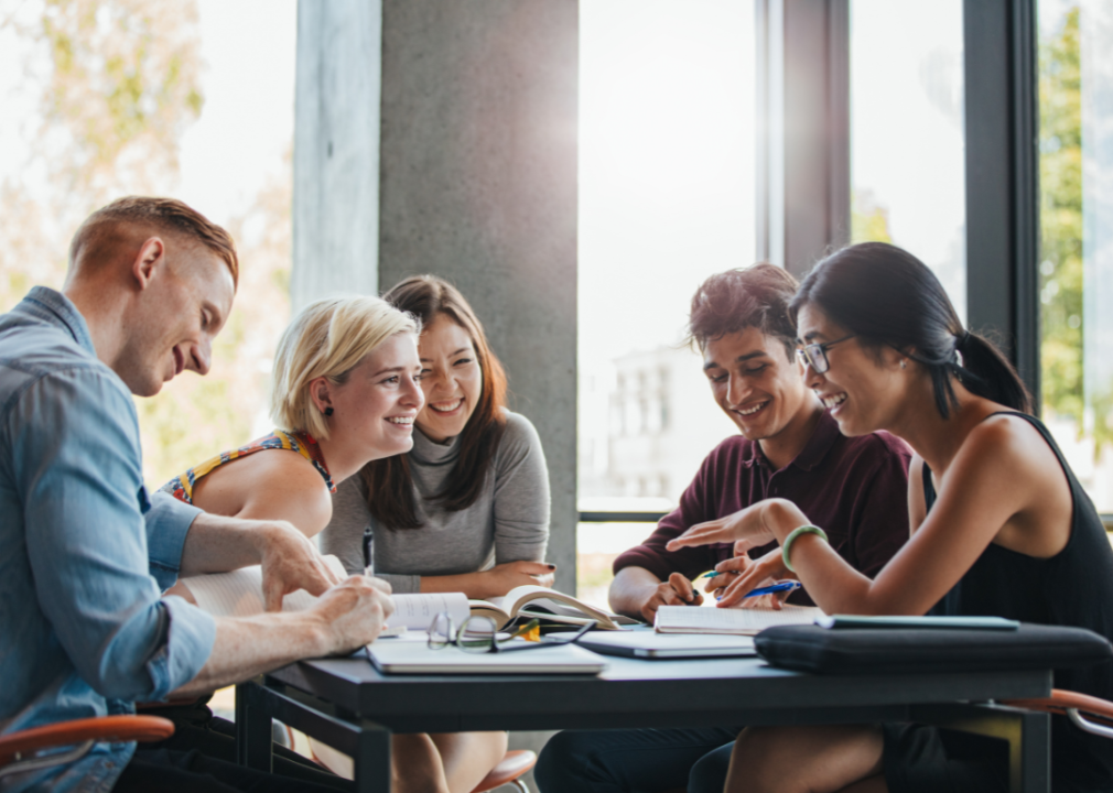 College students studying and laughing together.