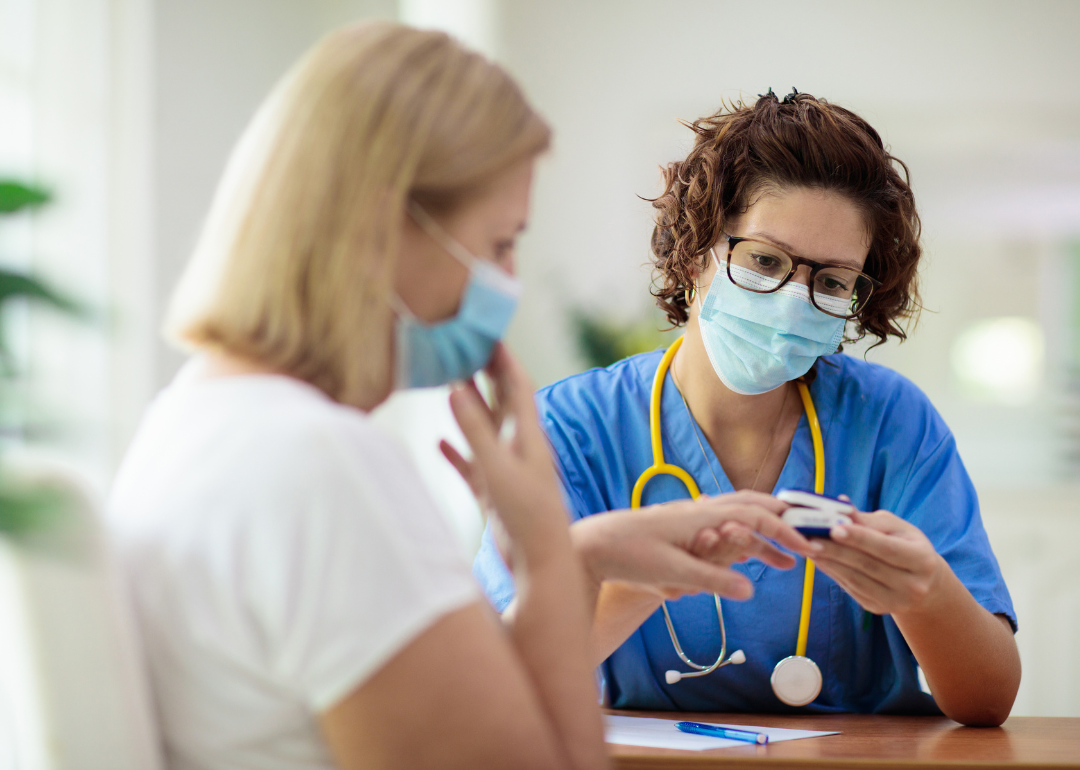 A woman doctor talking with a patient.