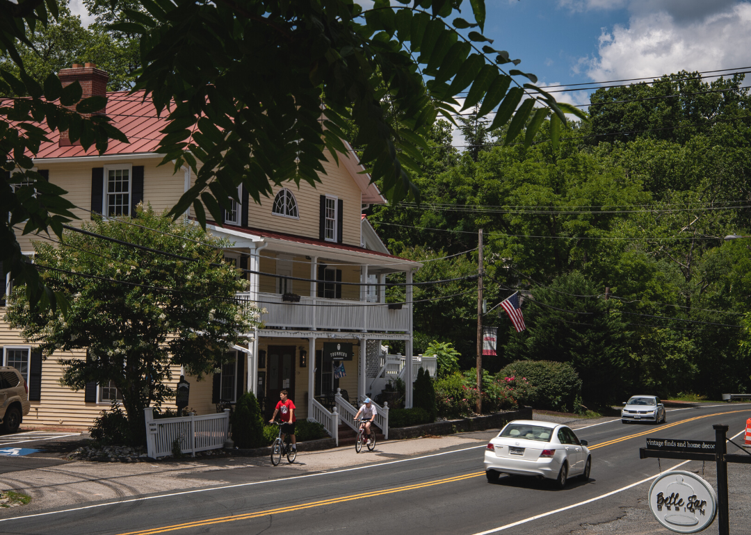 Two bikers riding down Main Street in Clifton, Virginia.