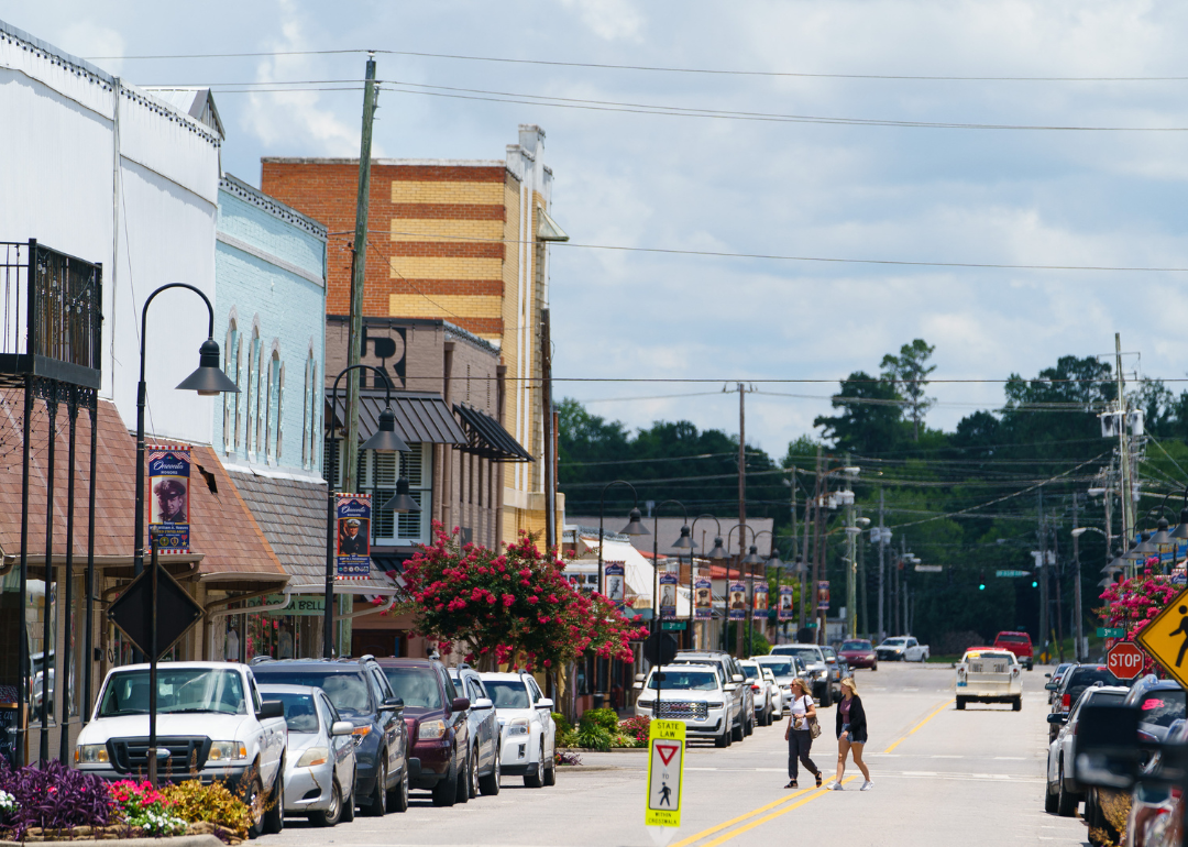 Two women walking across a street in downtown Oneonta, Alabama, on June 30, 2021.