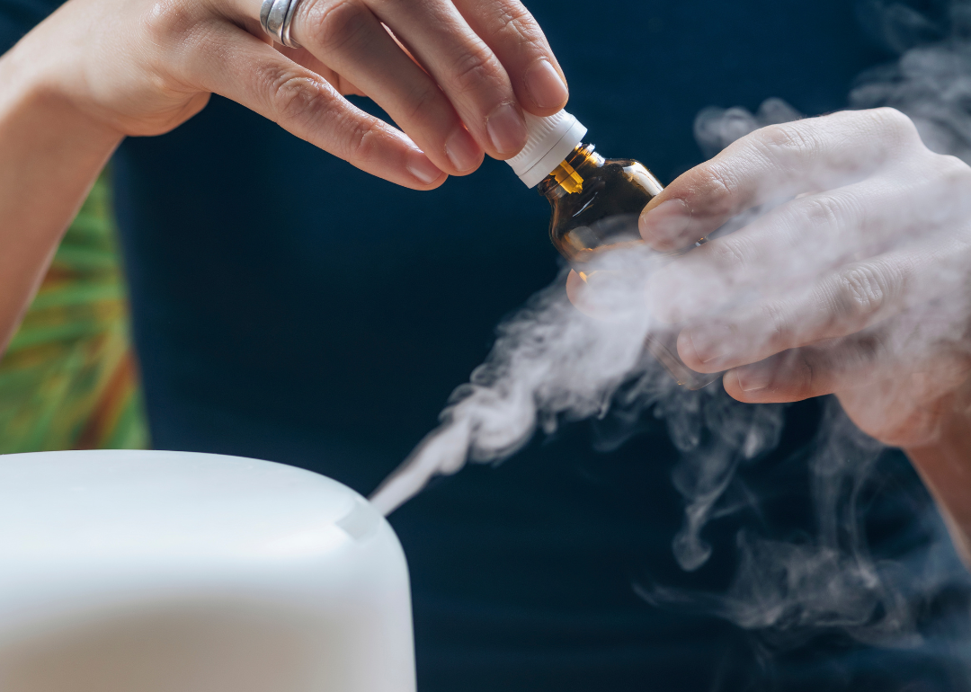 A person setting up a diffuser for aromatherapy.