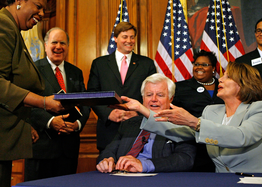 Speaker of the House Nancy Pelosi handing the College Cost Reduction Act of 2007 to Clerk of the House Lorraine C. Miller. The bill increases access to Pell Grants.