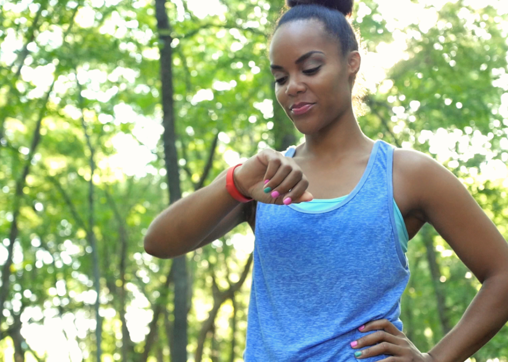 A woman checking her smart watch while working out